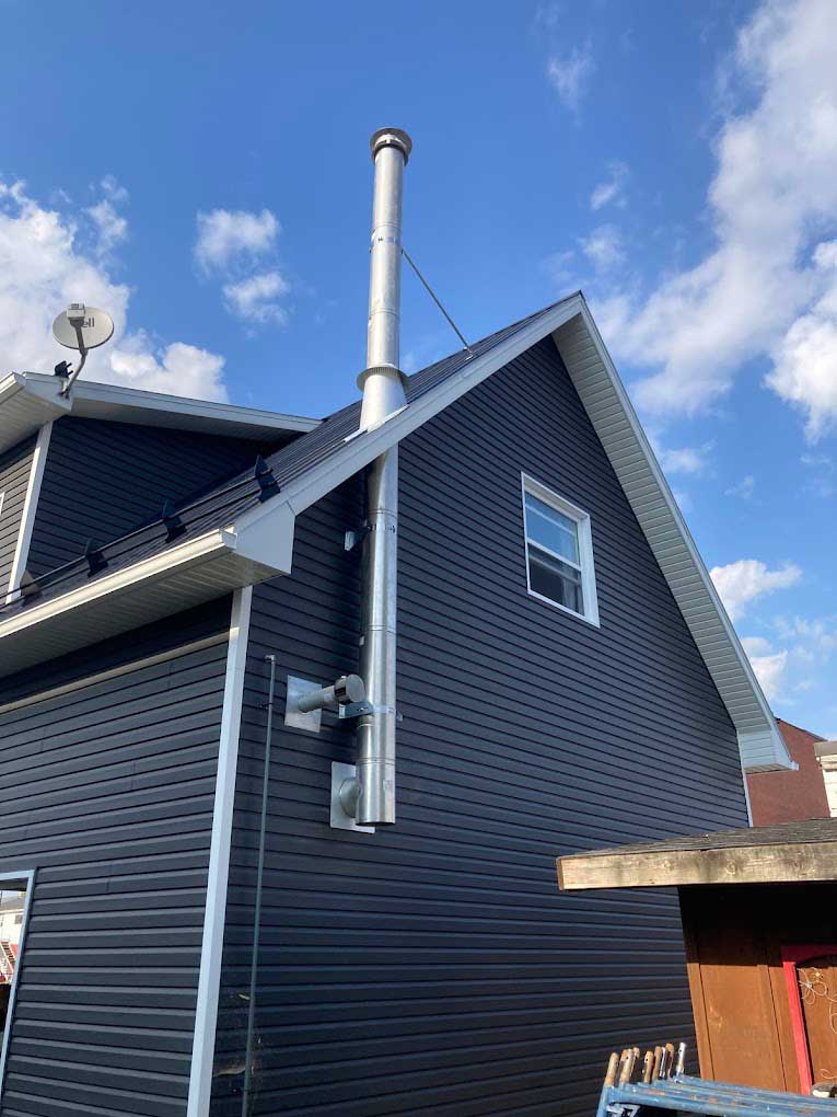 Chimney installation on blue residential home