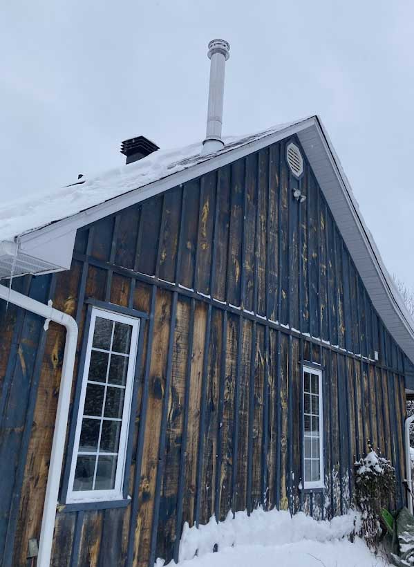Barn chimney installation in winter