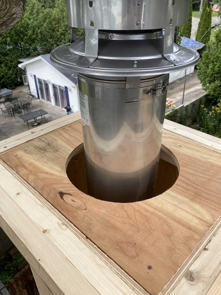 Professional chimney installation on residential roof